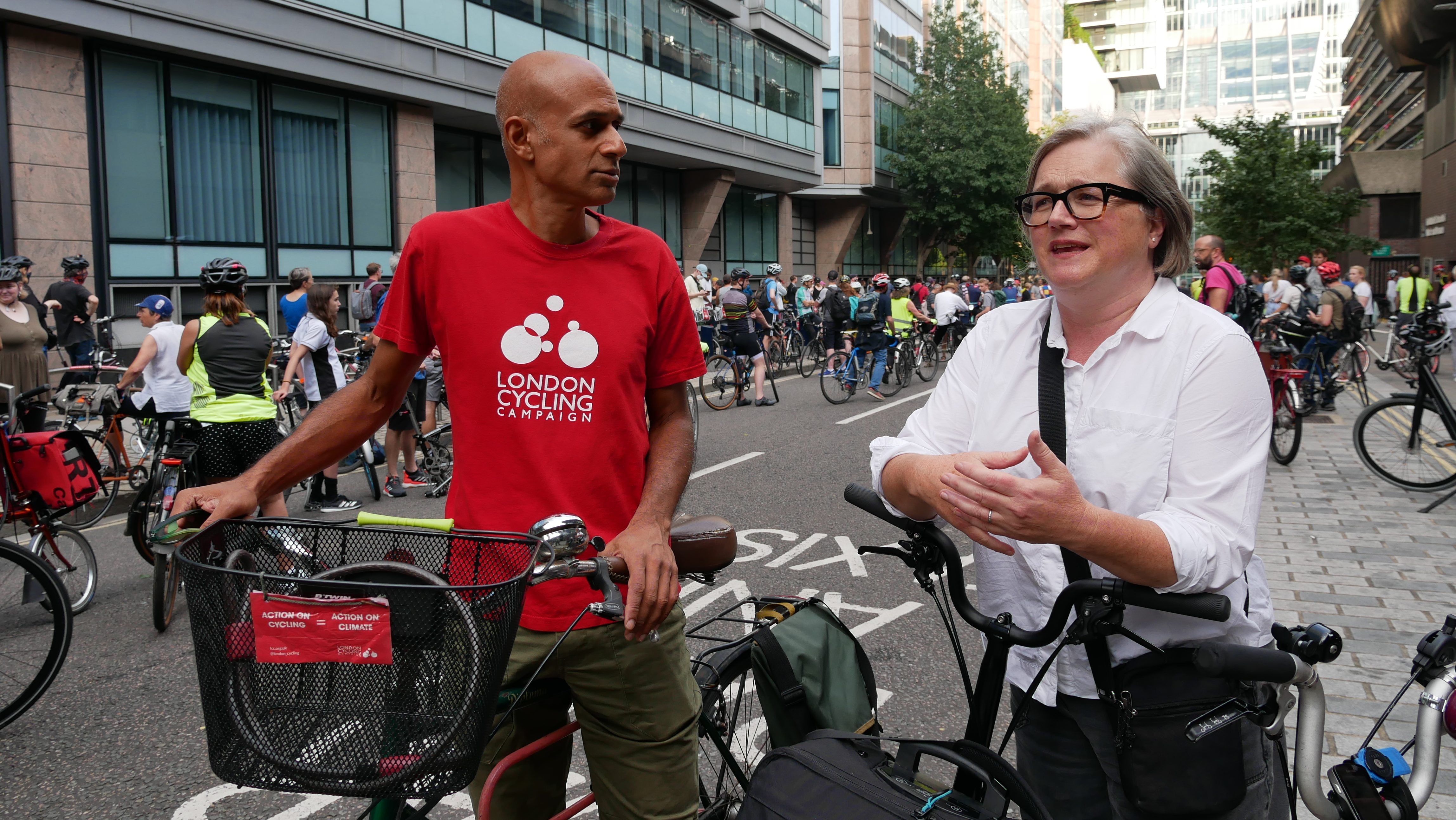 Caroline Russell speaks with a London Cycling Campaign activist while standing over their bikes. 