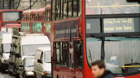 Snapshot of London's congested roads, featuring iconic red double decker buses and smaller vehicles.