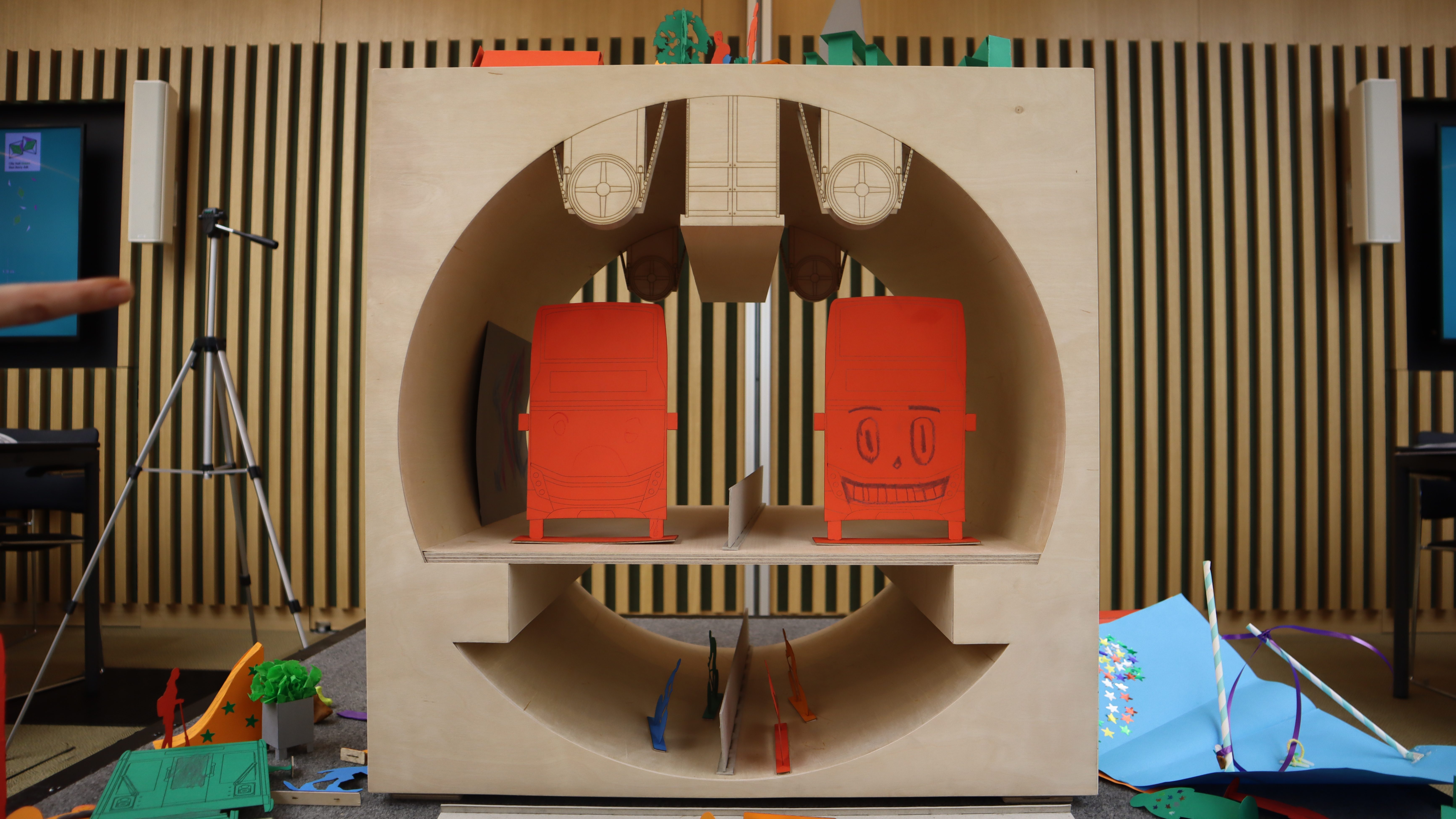 A close-up of Siân's Silvertown Road Tunnel model, featuring buses with cartoon faces and a space for pedestrians.